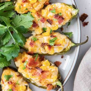 Corn dip stuffed jalapenos with bacon on top