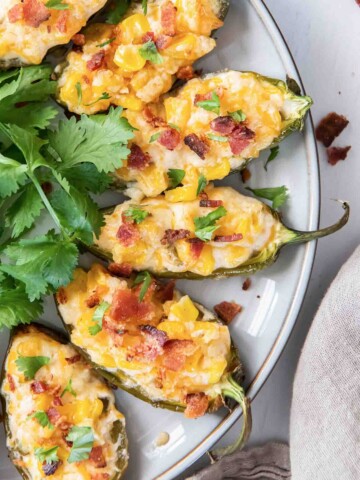Corn dip stuffed jalapenos with bacon on top