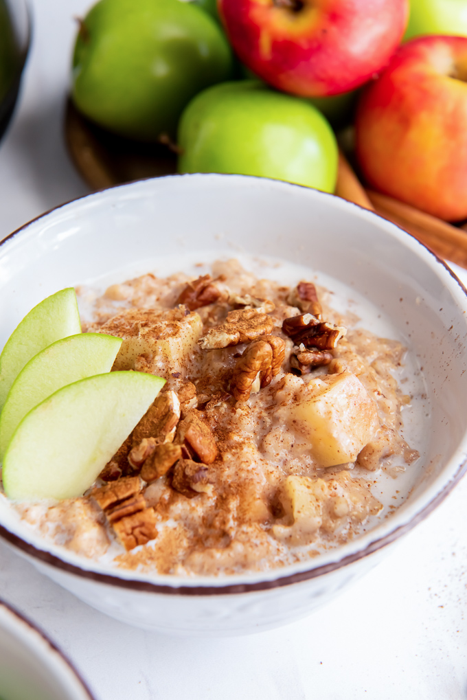 Apple slow cooker steel cut oats in a bowl with sliced apples
