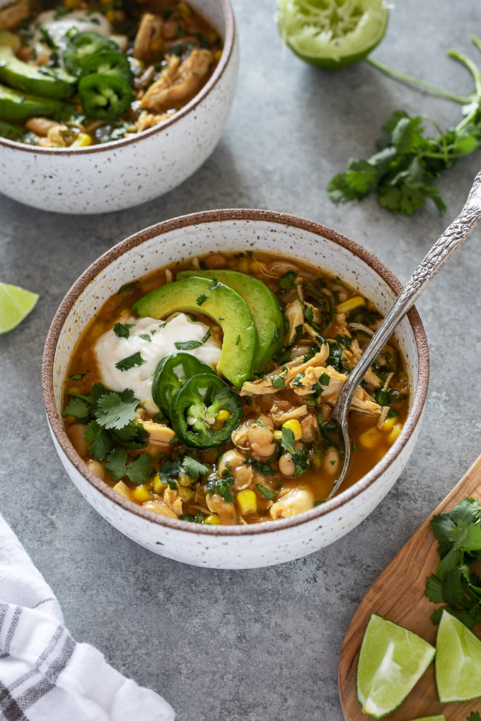 White bean chicken chili in a bowl with spoon nestled inside