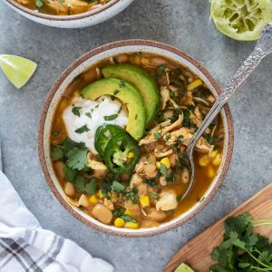 Bowl of instant pot white chicken chili with spoon digging in