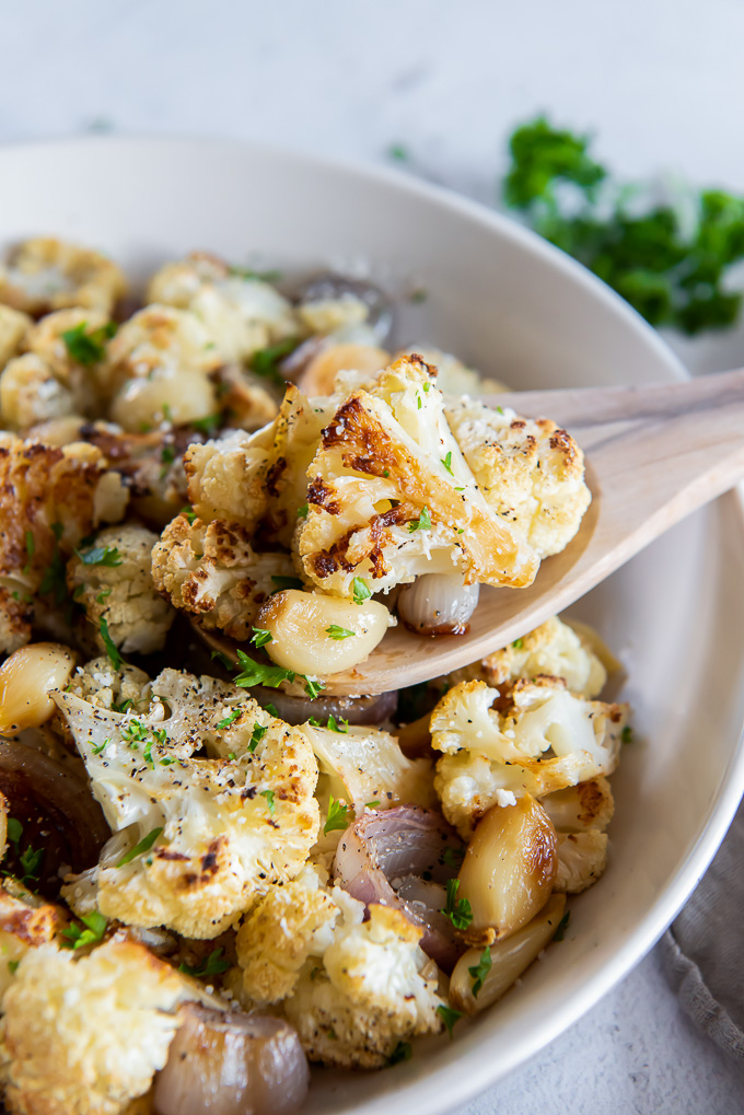 Spoonful of roasted cauliflower over a serving bowl
