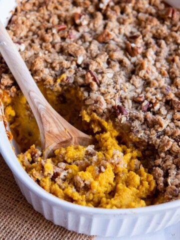Wooden spoon digging into Butternut Squash Casserole
