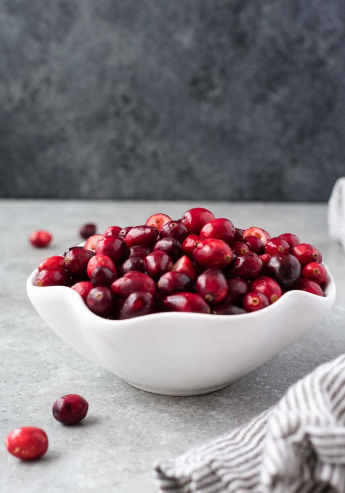 White bowl filled with fresh cranberries