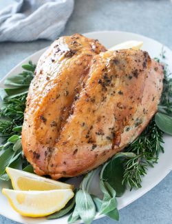 Herb and garlic roasted turkey breast on a serving platter