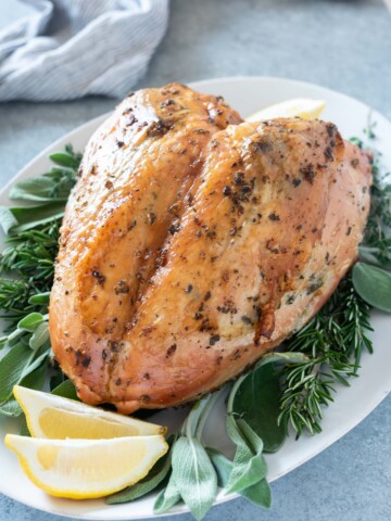 Herb and garlic roasted turkey breast on a serving platter