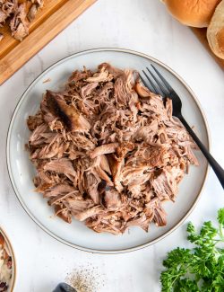 Slow cooker pulled pork on a white plate