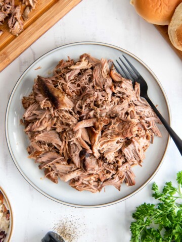 Slow cooker pulled pork on a white plate