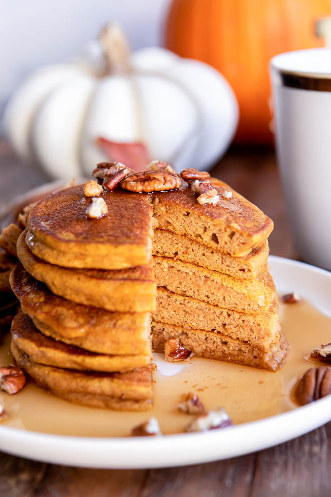 Stack of pumpkin pancakes on a plate with bite removed