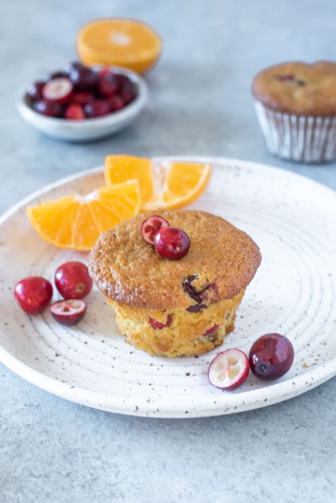 Healthy cranberry orange muffin on a white plate