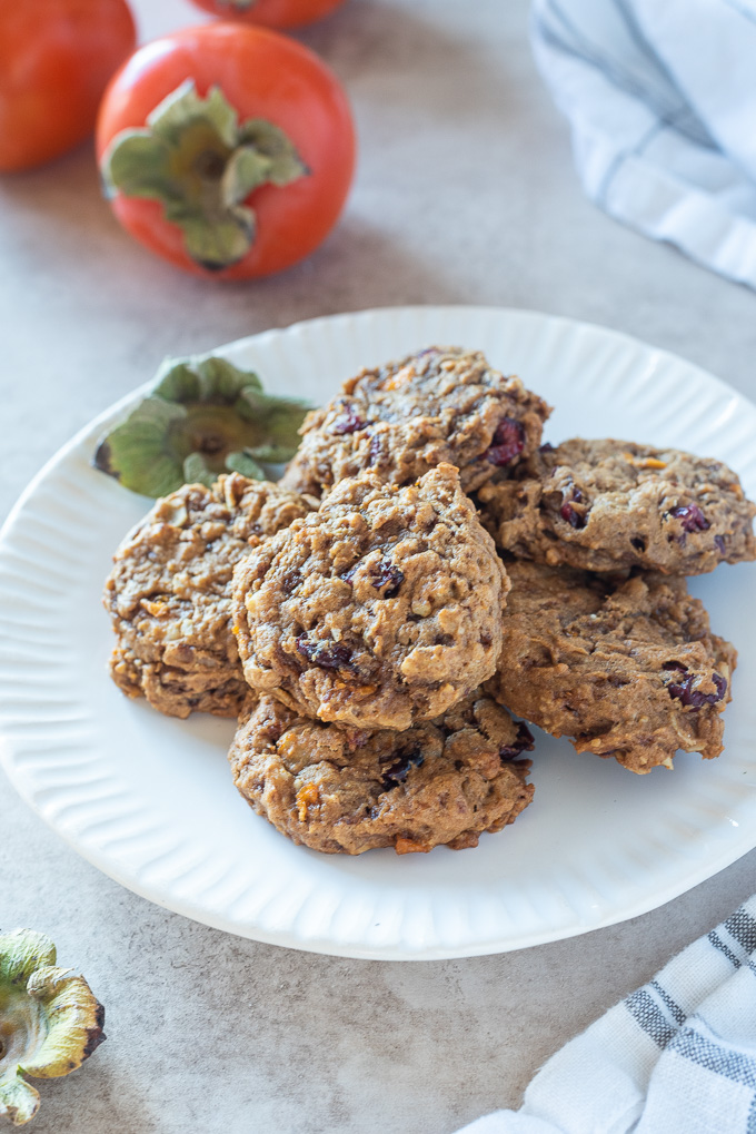 Persimmon oatmeal cookies piled on a white plate