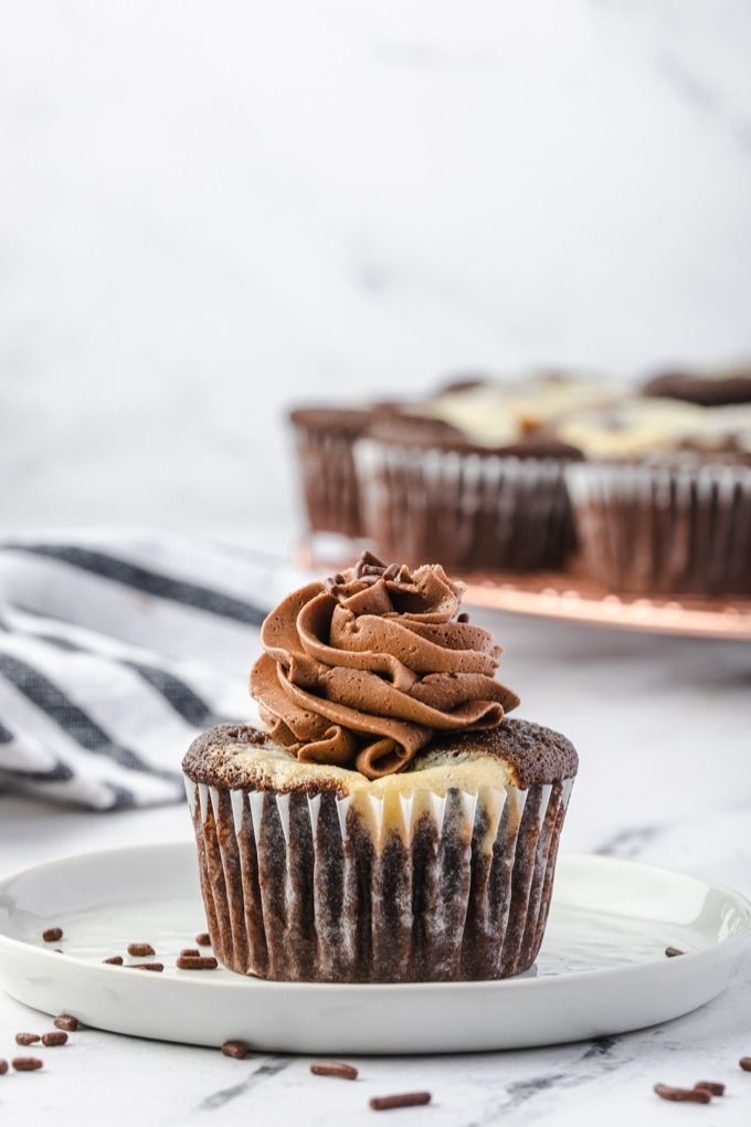 Black bottom cupcake with chocolate frosting on a plate