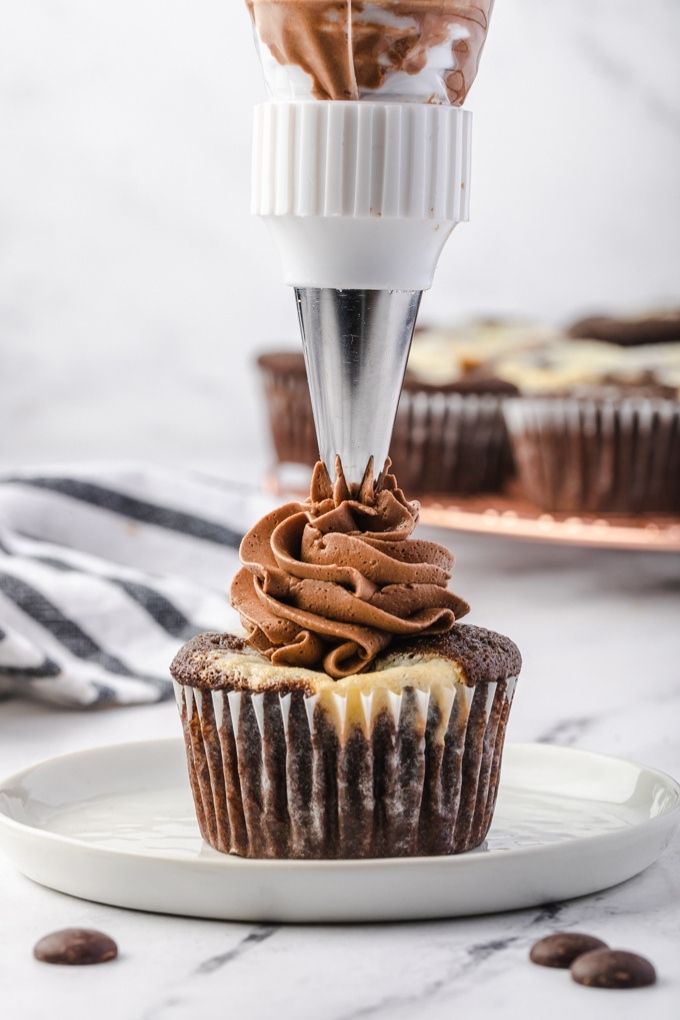 Chocolate buttercream frosting piped onto a black bottom cupcake