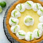 Key lime pie with whipped cream and lime slices