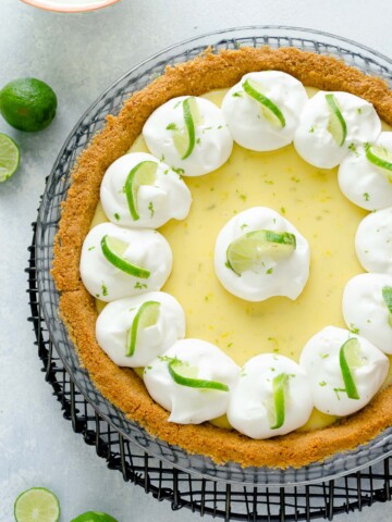 Key lime pie with whipped cream and lime slices