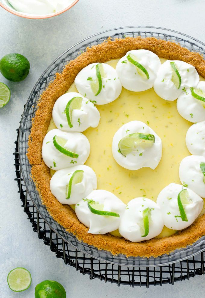 Key lime pie with whipped cream and lime slices
