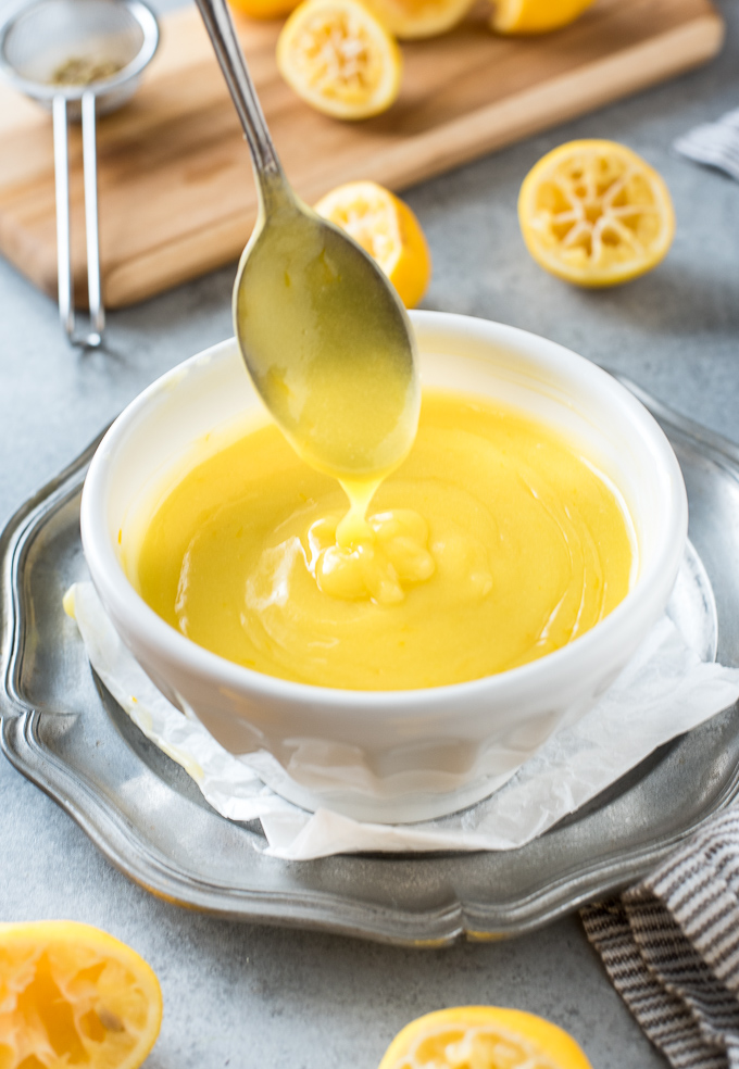 Lemon curd drizzling from a spoon