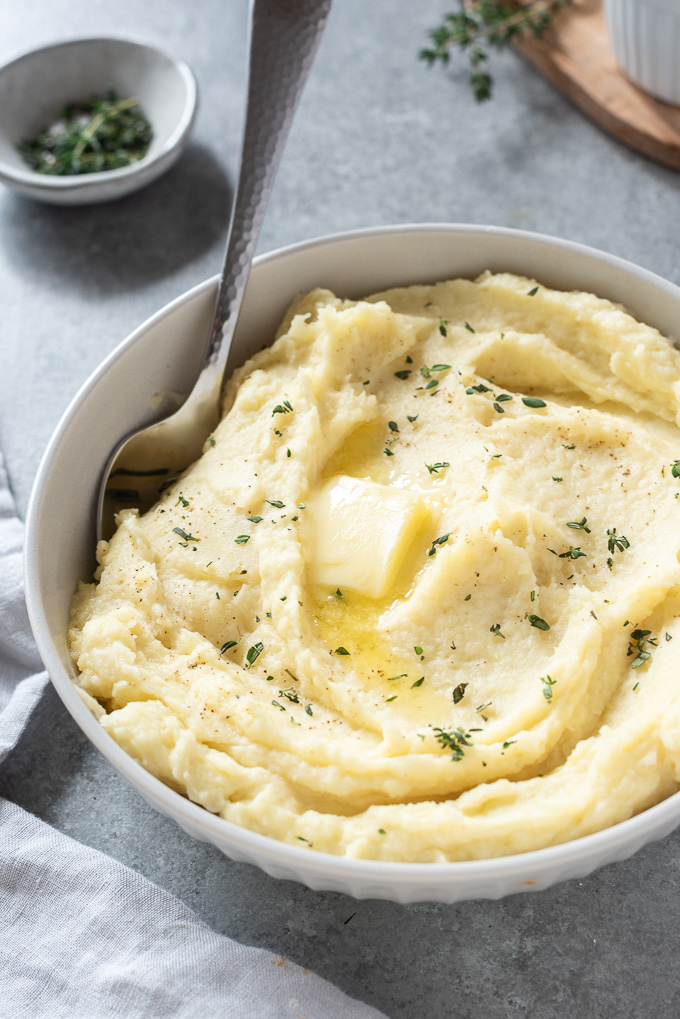Parsnip puree in a serving bowl with butter melting on top