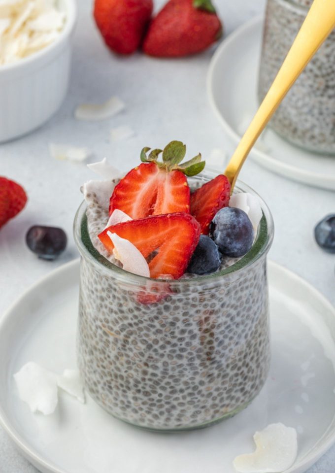 Chia seed pudding in a jar with a spoon digging in