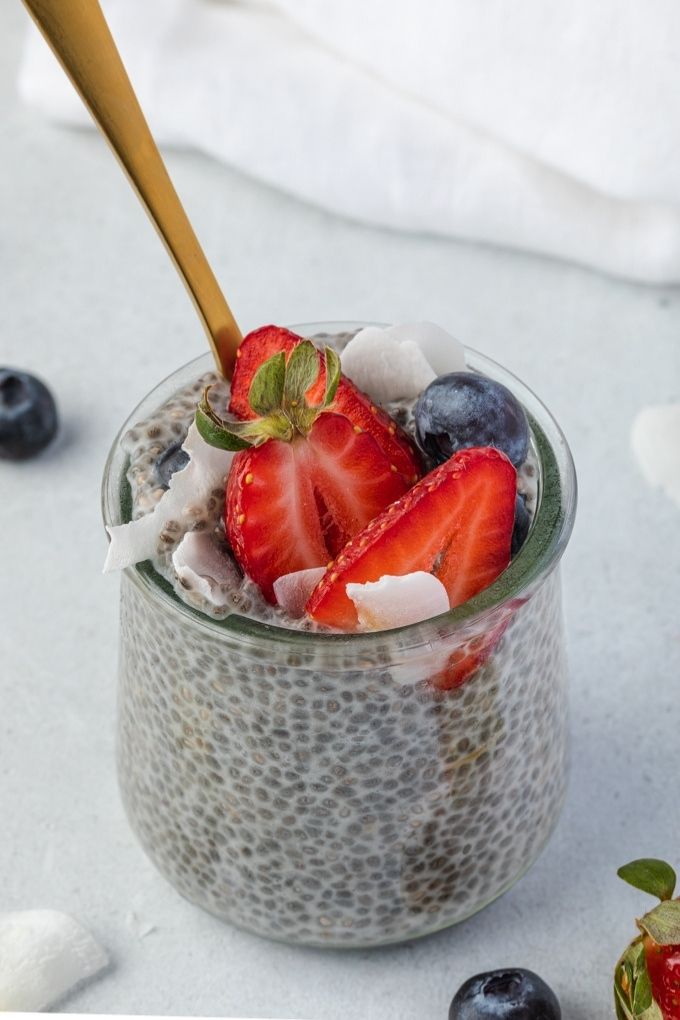 Chia seed pudding in a jar topped with berries and coconut