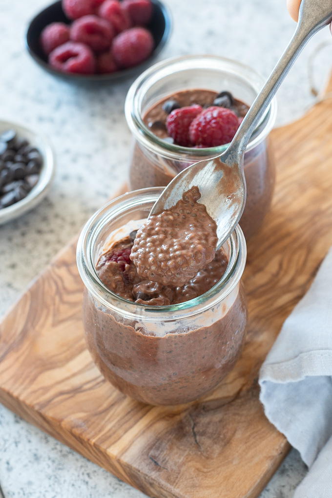 Spoonful of chocolate chia seed pudding over a jar