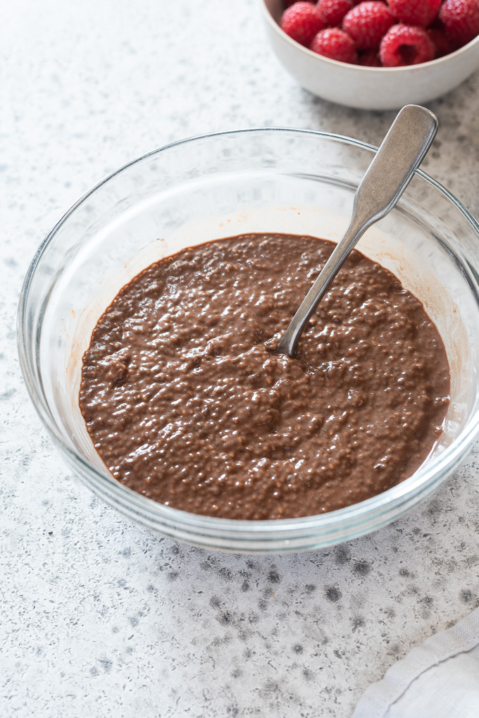 Chocolate chia pudding in a mixing bowl with a spoon