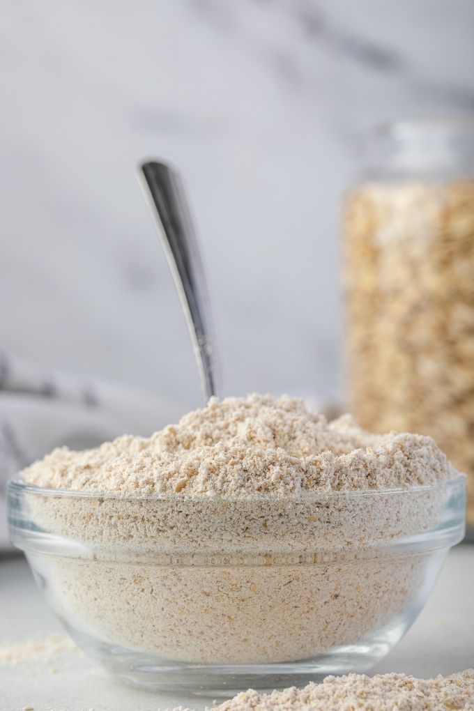 Oat flour in a bowl with a large spoon
