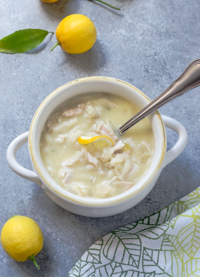 Slow cooker Greek lemon chicken soup in a white bowl