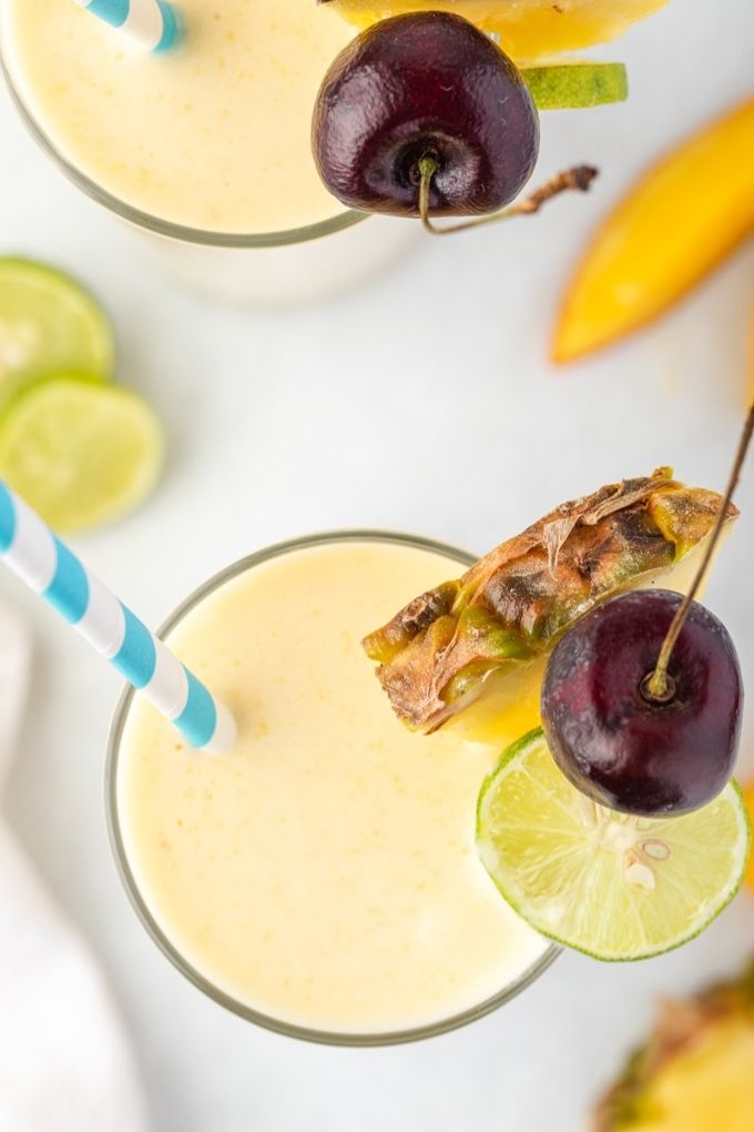 Tropical smoothie with pineapple, cherry and lime garnish