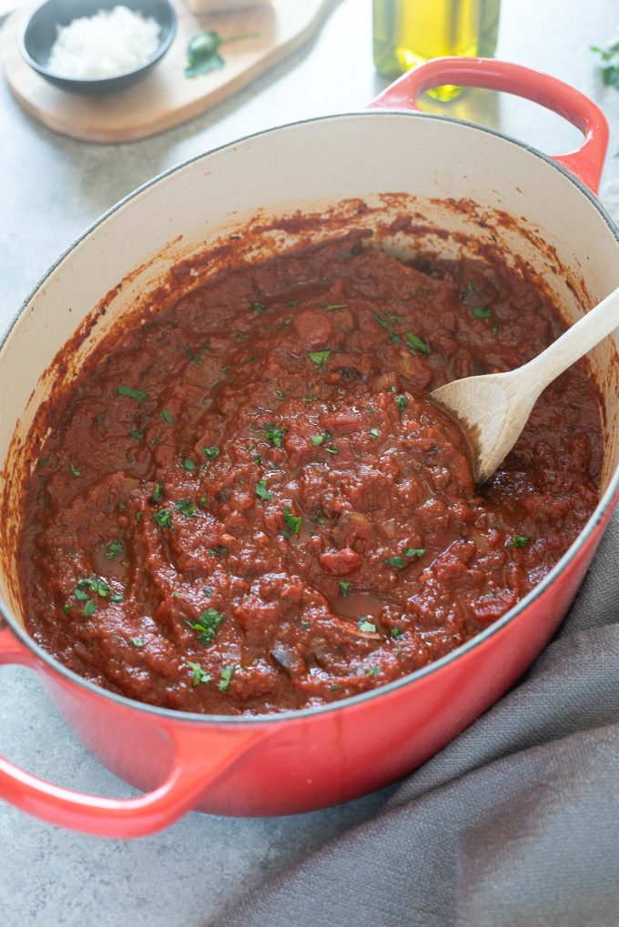Homemade meat sauce in a Dutch oven with parsley