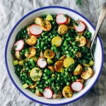 Spring potato salad in a bowl with a serving spoon