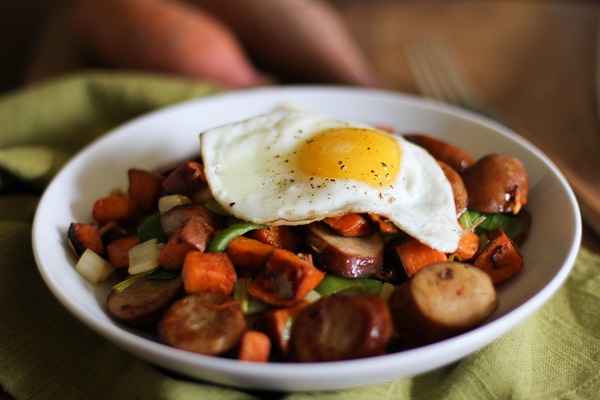 Sweet potato and leek hash in a bowl with egg on top