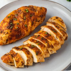 Air fryer chicken breast sliced on a plate