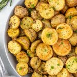 Air fryer potatoes in a bowl with rosemary