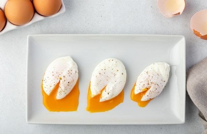 Comparison of soft, medium and hard poached eggs on a platter