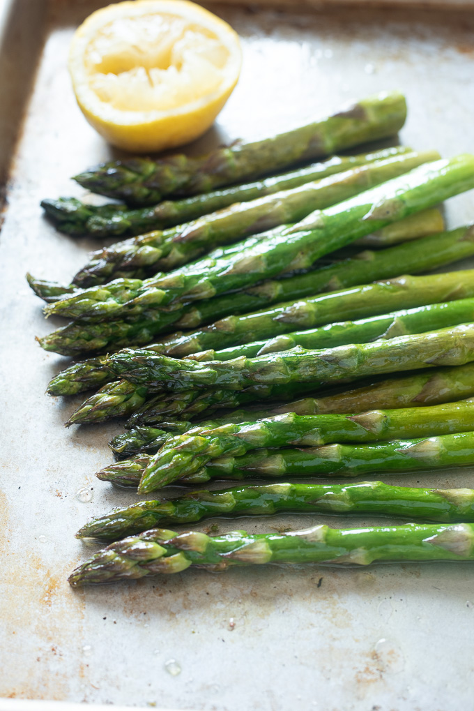Oven roasted asparagus on a sheet pan with lemon