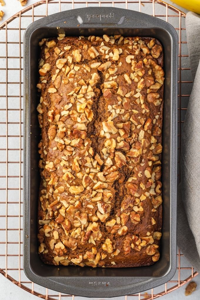 Loaf of banana nut bread on a cooling rack