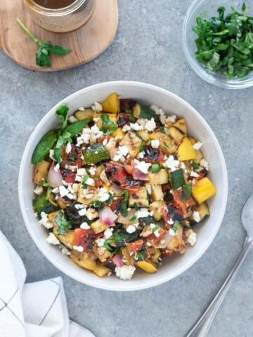 Bowl of grilled vegetable salad with linen
