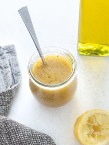 Jar of red wine vinaigrette with spoon in it