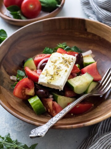 Horiatiki in a bowl with a fork