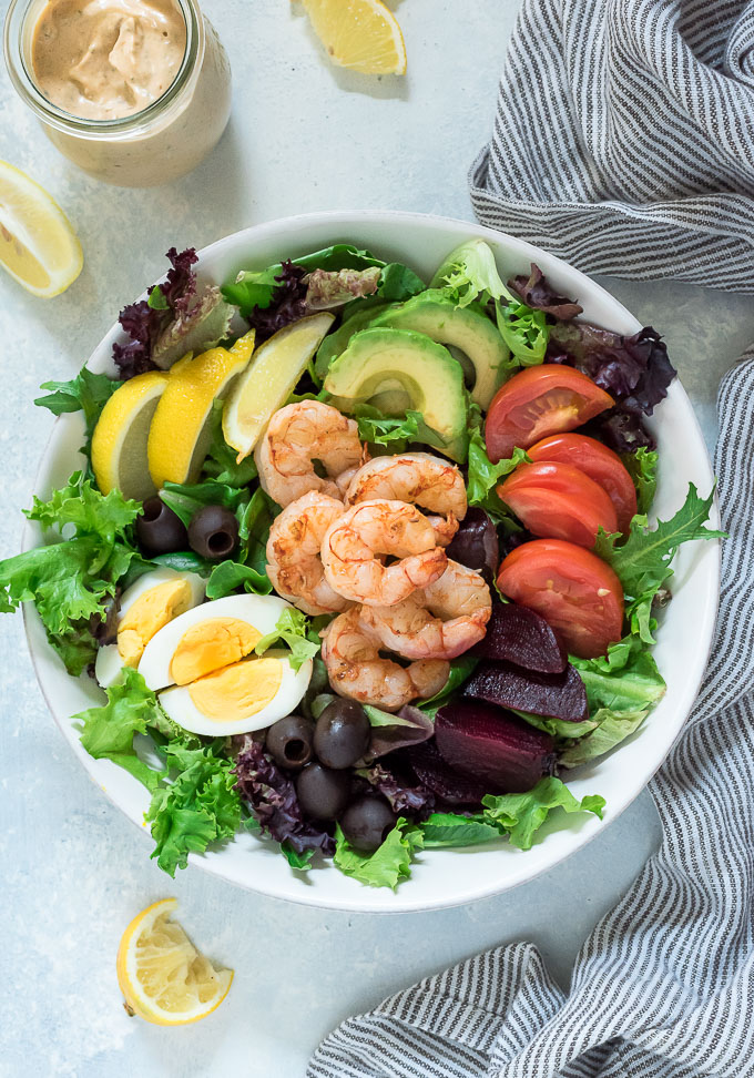 Shrimp louie salad in a white bowl with no dressing