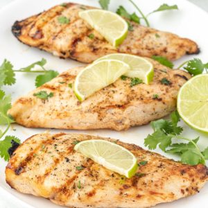 Grilled tequila lime chicken on a white platter