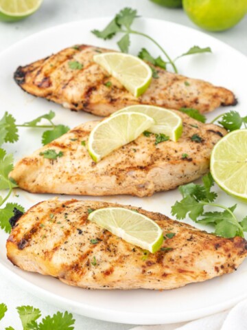 Grilled tequila lime chicken on a white platter