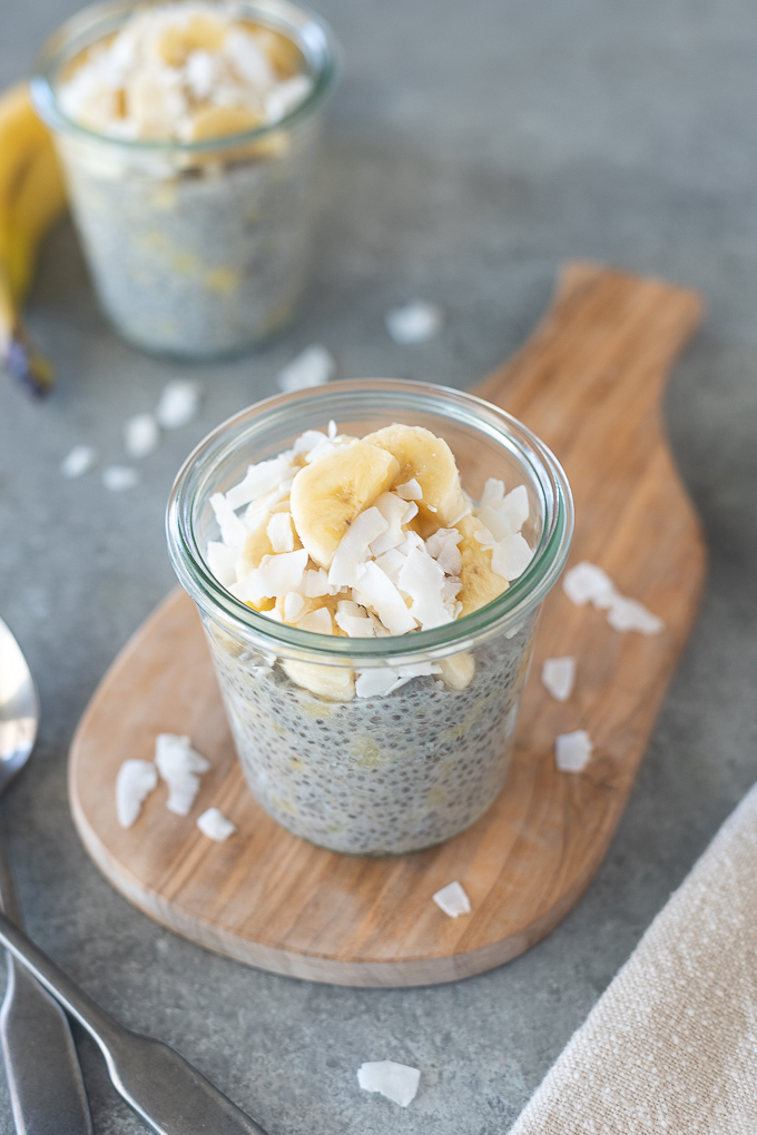 Banana chia seed pudding in a jar with coconut flakes