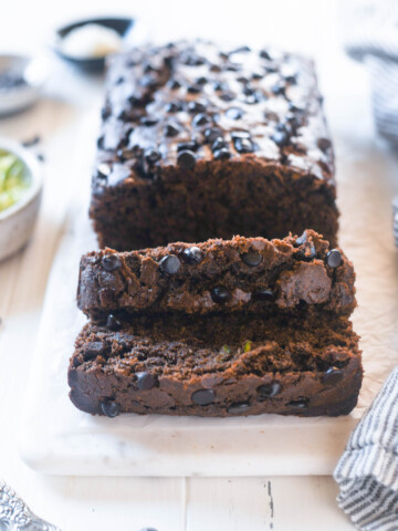 Double chocolate zucchini loaf sliced on a board
