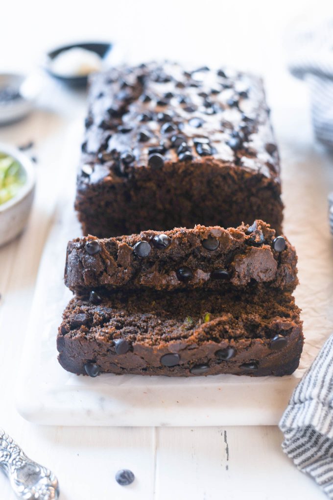 Double chocolate zucchini loaf sliced on a board