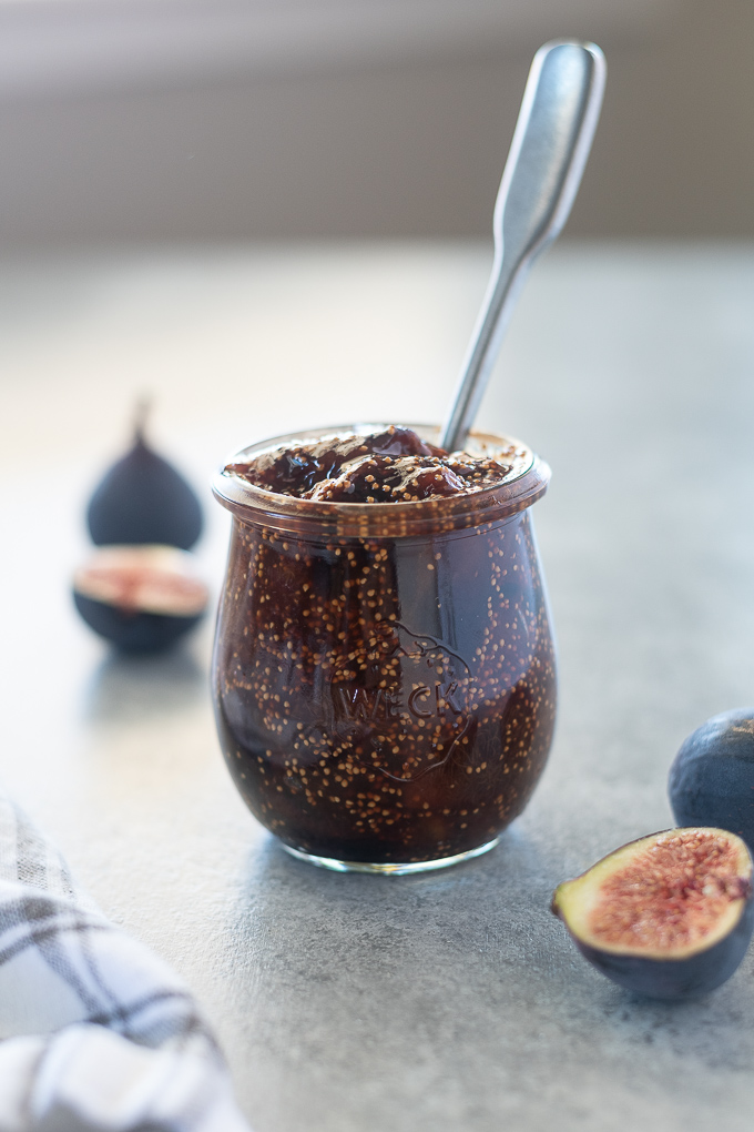Spoon buried in a jar of fig jam