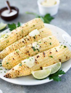 Grilled corn on the cob with butter and lime