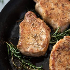 Oven baked pork chops in a cast iron skillet