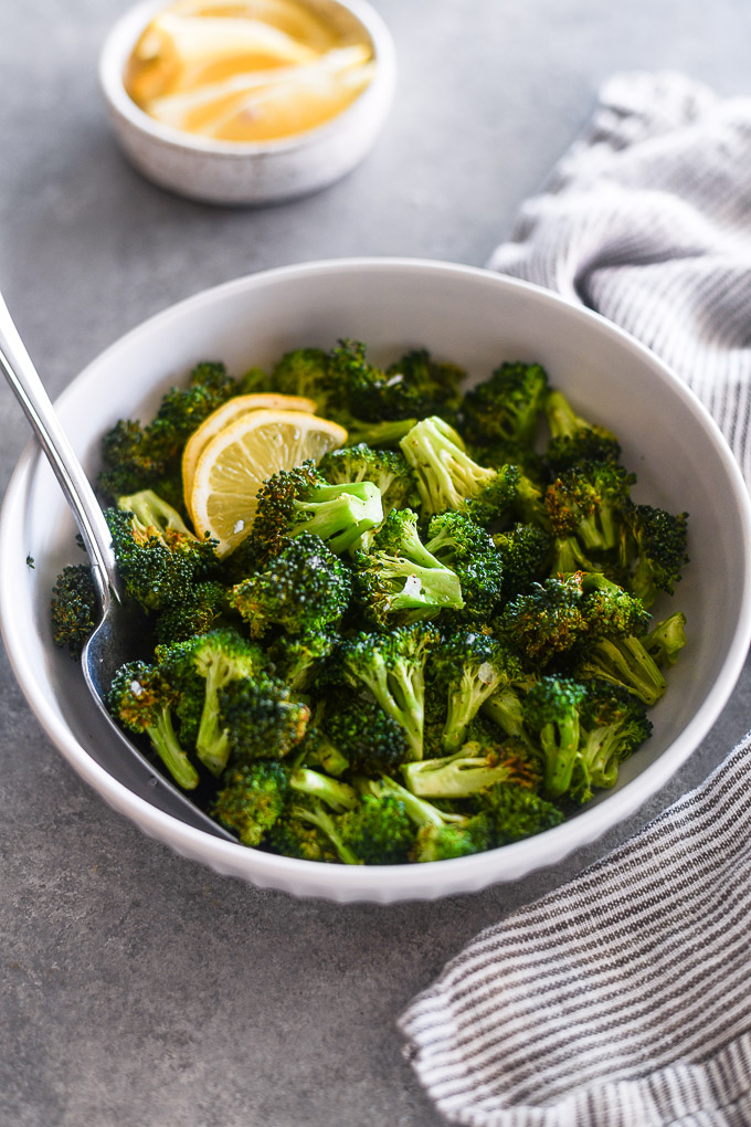 Spoon in bowl of air fryer broccoli
